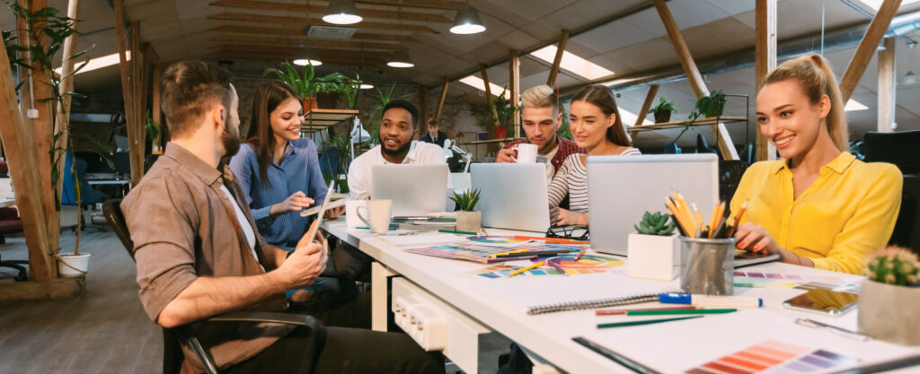 Multicultural team of digital experts collaborating in a creative workspace — representing Hubliik’s global and multilingual support.